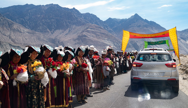 Local people in traditional dress lining the road to welcome His Holiness the Dalai Lama to Nubra Valley in Ladakh, J&K, India on July 12, 2018. Photo by Tenzin Choejor