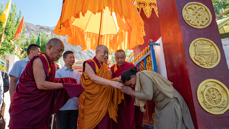 His Holiness the Dalai Lama greeting a woman on the security team on his way to the teaching ground for the Inauguration of the Great Summer Debate at Samstanling Monastery in Sumur, Ladakh, J&K, India on July 15, 2018. Photo by Tenzin Choejor