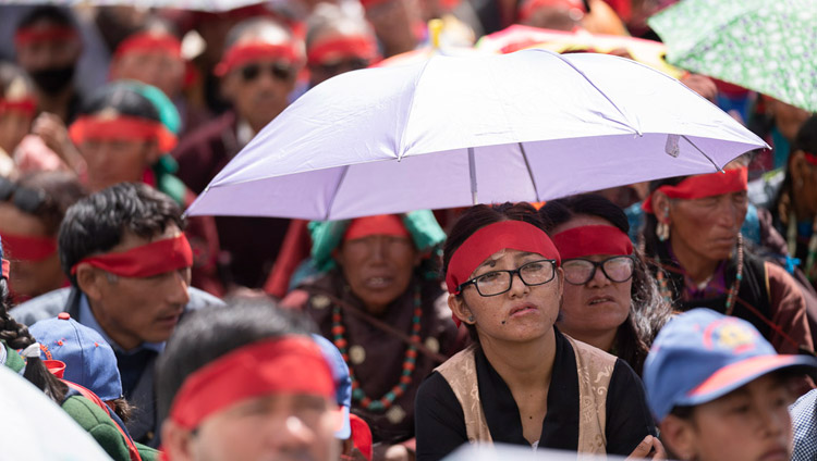 Some members of the audience using umbrellas to protect against the sun during the Avalokiteshvara empowerment given by His Holiness the Dalai Lama in Padum, Zanskar, J&K, India on July 23, 2018. Photo by Tenzin Choejor