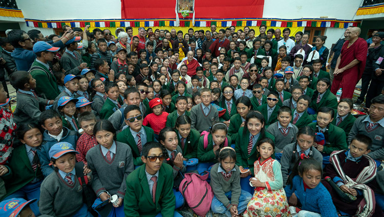His Holiness the Dalai Lama posing for a group photo with students and staff at the end of his talk at Lamdon Model School in Padum, Zanskar, J&K, India on July 24, 2018. Photo by Tenzin Choejor
