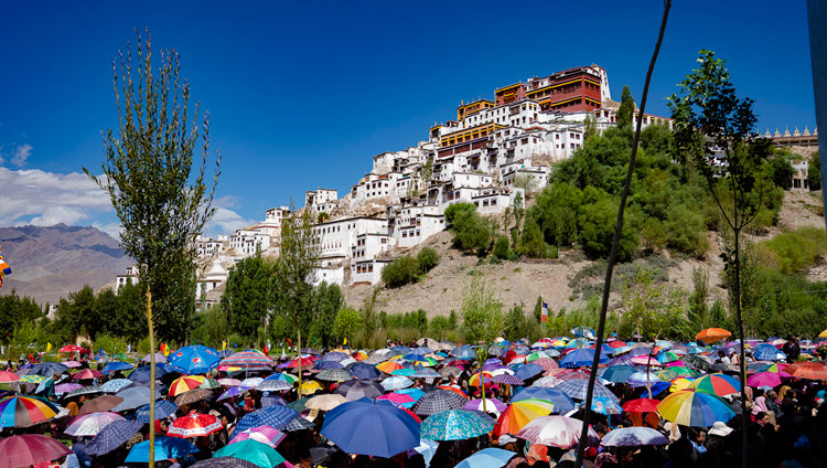 A view of Thiksey Monastery on the hill as many of the 2,500 people attending the ground breaking ceremony of the Library and Learning Centre use umbrellas to protect from the sun in Leh, Ladakh, J&K, India on July 29, 2018. Photo by Tenzin Choejor