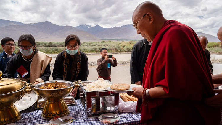 His Holiness the Dalai Lama serving himself during lunch organized by LAHDC at Sindhu Ghat in Leh, Ladakh, J&K, India on July 29, 2018. Photo by Tenzin Choejor