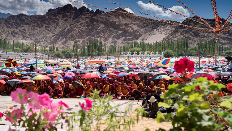 Many of the more than 20,000 attending His Holiness the Dalai Lama's teaching protect themselves from the sun at the Shewatsel Teaching Ground in Leh, Ladakh, J&K, India on July 30, 2018. Photo by Tenzin Choejor