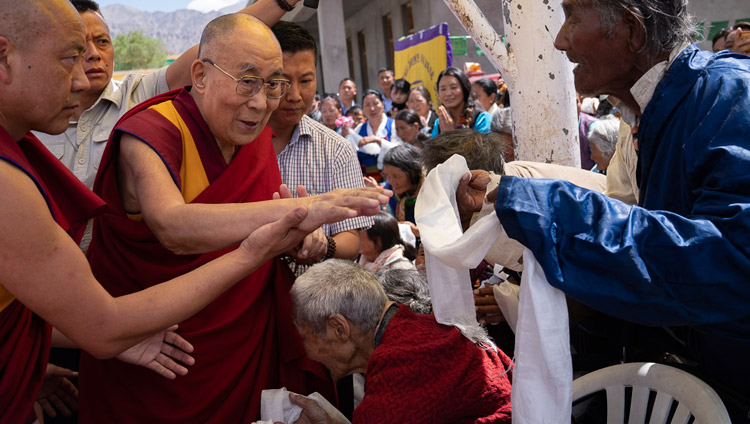 His Holiness the Dalai Lama greeting elderly Tibetans as he arrives at Tibetan Children’s Village School Choglamsar in Leh, Ladakh, J&K, India on August 1, 2018. Photo by Tenzin Choejor