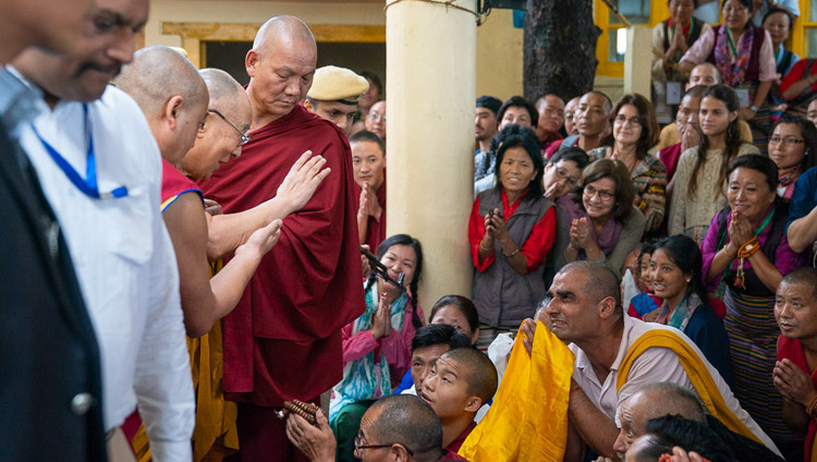 His Holiness the Dalai Lama greeting members of the audience sitting outside the Main Tibetan Temple as he departs for his residence at the conclusion of the first day of his teaching in Dharamsala, HP, India on September 4, 2018. Photo by Tenzin Choejor