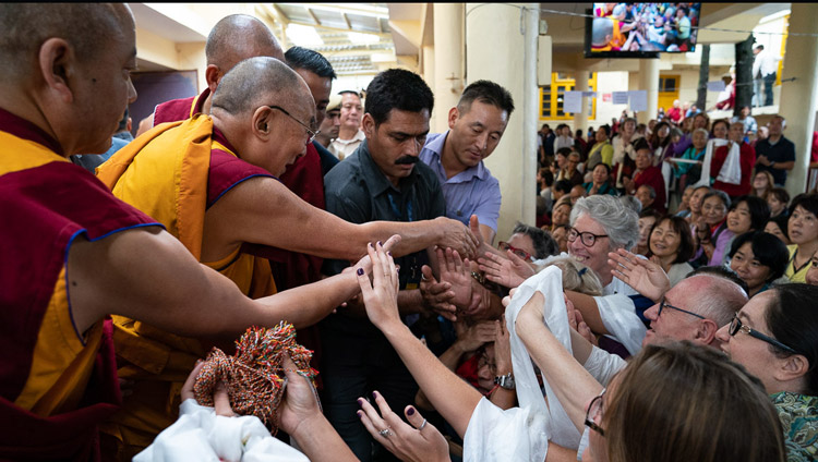His Holiness the Dalai Lama greeting members of the audience as he departs from the Main Tibetan Temple at the conclusion of the second day of his teachings at the Main Tibetan Temple in Dharamsala, HP, India on September 5, 2018. Photo by Tenzin Choejor His Holiness the Dalai Lama greeting members of the audience as he departs from the Main Tibetan Temple at the conclusion of the second day of his teachings at the Main Tibetan Temple in Dharamsala, HP, India on September 5, 2018. Photo by Tenzin Choejor
