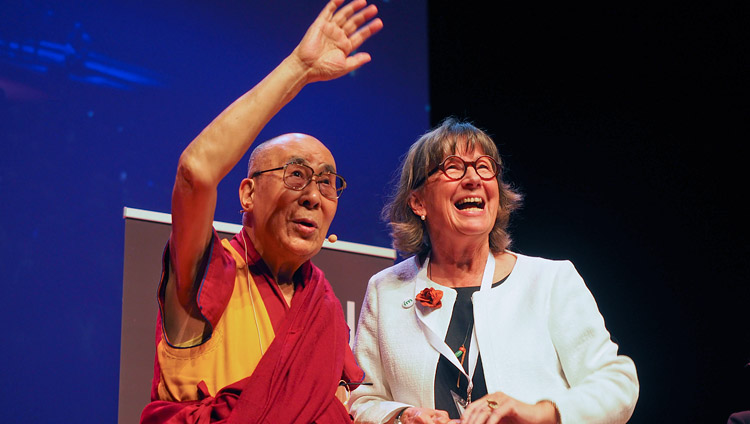 His Holiness the Dalai Lama with to the grandchildren of the Chair of IM Birthe Müller as they stand together on stage at the conclusion of his talk in Malmö, Sweden on September 12, 2018. Photo by Jeremy Russell