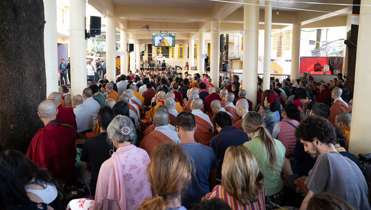 Members of the audience sitting outside the Main Tibetan Temple watching His Holiness the Dalai Lama on TV screens on the second day of teachings in Dharamsala, HP, India on October 4, 2018. Photo by Ven Tenzin Jamphel