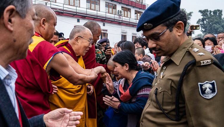 His Holiness the Dalai Lama greeting greeting friends and well-wisher as he walks to the Mahabodhi Temple in Bodhgaya, Bihar, India on December 17, 2018. Photo by Tenzin Choejor