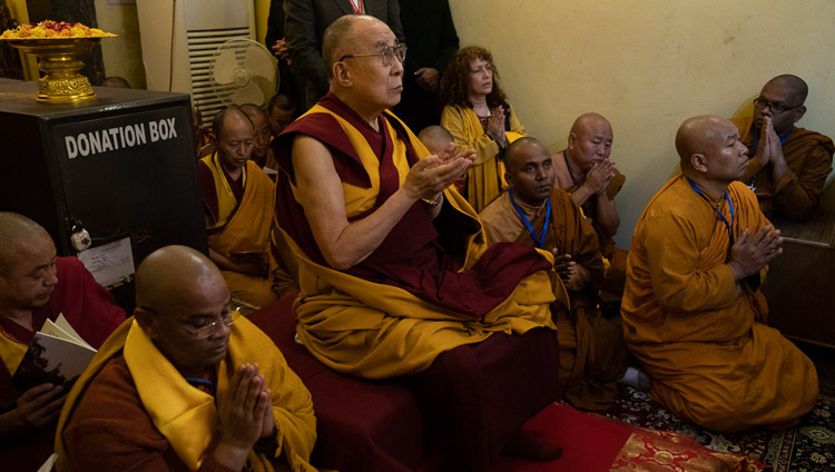 His Holiness the Dalai Lama joining in recitations of praises and prayers before the statue of Shakyamuni Buddha inside the Mahabodhi Temple in Bodhgaya, Bihar, India on December 17, 2018. Photo by Tenzin Choejor