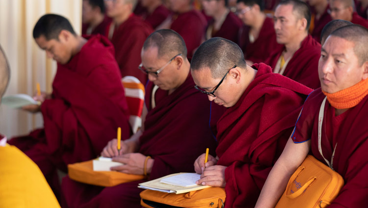 Members of the audience taking notes during His Holiness the Dalai Lama's address at the Conference on Tsongkhapa's ‘Essence of True Eloquence’ in Bodhgaya, Bihar, India on December 19, 2018. Photo by Lobsang Tsering