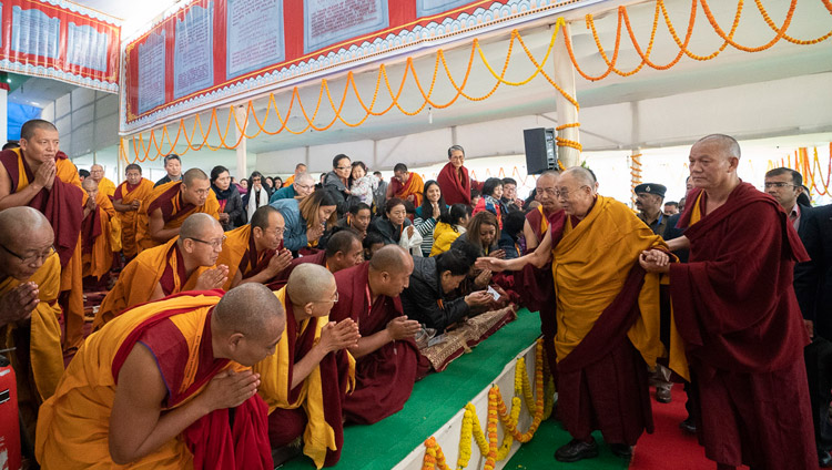 His Holiness the Dalai Lama greeting friends and waving to members of the audience as he arrives at the Kalachakra Ground in Bodhgaya, Bihar, India on December 24, 2018. Photo by Lobsang Tsering