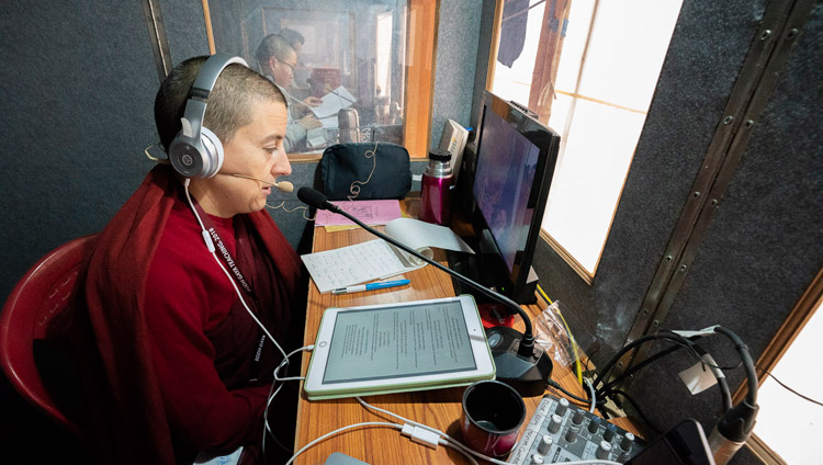 The Spanish interpreter, one of 13 languages being translated, working in her translation booth on the first day of His Holiness the Dalai Lama's teaching in Bodhgaya, Bihar, India on December 24, 2018. Photo by Lobsang Tsering