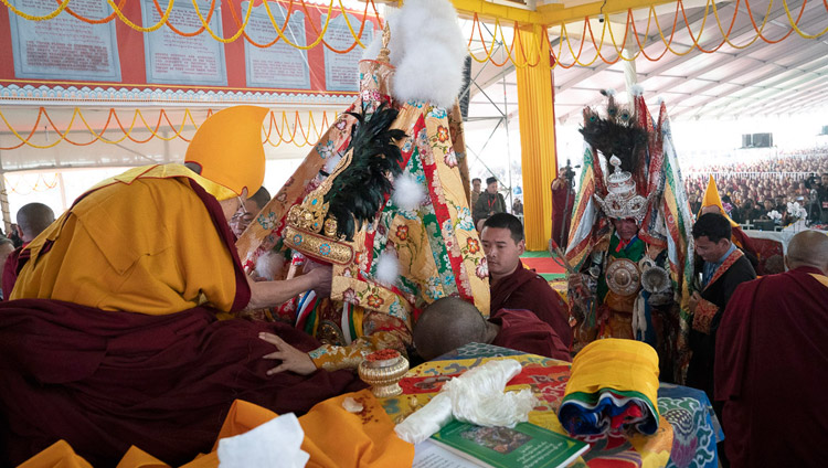 His Holiness the Dalai Lama and Nechung Dorje Drakden with the oracle of Nyenchen Thangla behind during the Long Life Ceremony at the Kalachakra Ground in Bodhgaya, Bihar, India on December 31, 2018. Photo by Lobsang Tsering