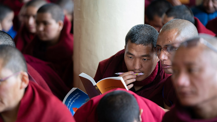 Monks in the audience following the text as His Holiness the Dalai Lama reads from Bhavaviveka's "Essence of the Middle Way" on the first day of his teachings at the Main Tibetan Temple in Dharamsala, HP, India on February 20, 2019. Photo by Tenzin Choejor