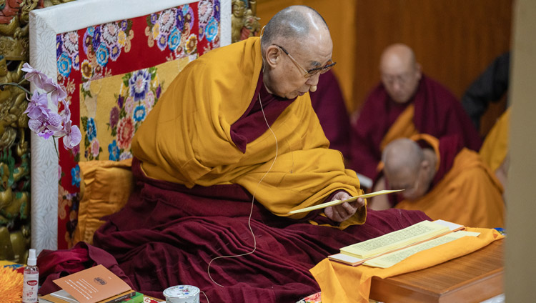 His Holiness the Dalai Lama reading from Bhavaviveka's "Essence of the Middle Way" on the second day of his teachings in Dharamsala, HP, India on February 21, 2019. Photo by Tenzin Choejor