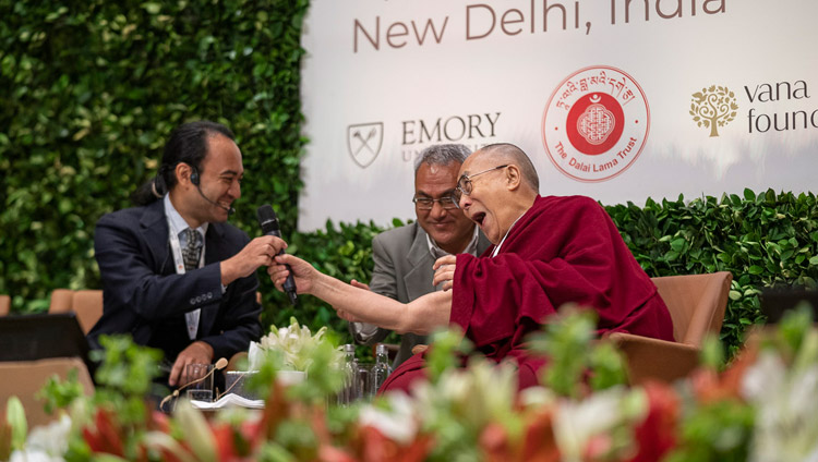 His Holiness the Dalai Lama playfully handing Brendan Ozawa-de Silva his microphone during the panel discussion at the global launch of SEE Learning in New Delhi, India on April 5, 2019. Photo by Tenzin Choejor