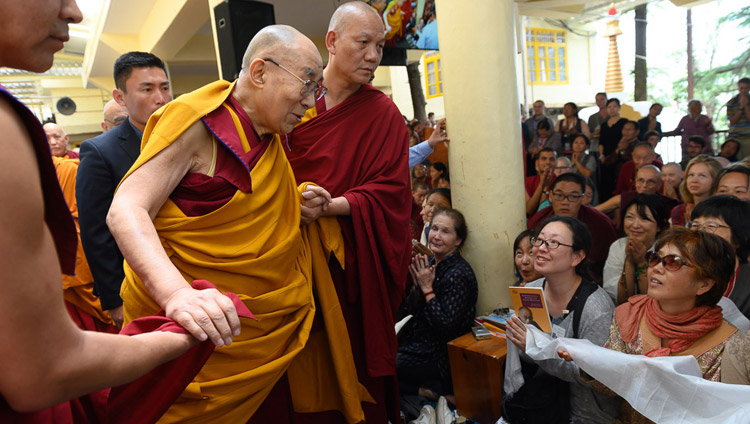 His Holiness the Dalai Lama greeting members of the audience as he leaves at the end of the first day of his teachings at the Main Tibetan Temple in Dharamsala, HP, India on May 10, 2019. Photo by Tenzin Choejor