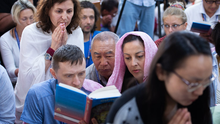 Members of the audience looking at the text on the final day of His Holiness the Dalai Lama's teaching at the request of Russian Buddhists at the Main Tibetan Temple in Dharamsala, HP, India on May 12, 2019. Photo by Lobsang Tsering