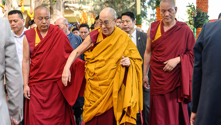 His Holiness the Dalai Lama walking through the courtyard on the way to the Main Tibetan Temple to attend an offering of prayers for his long life in Dharamsala, HP, India on May 17, 2019. Photo by Tenzin Choejor His Holiness the Dalai Lama walking through the courtyard on the way to the Main Tibetan Temple to attend an offering of prayers for his long life in Dharamsala, HP, India on May 17, 2019. Photo by Tenzin Choejor