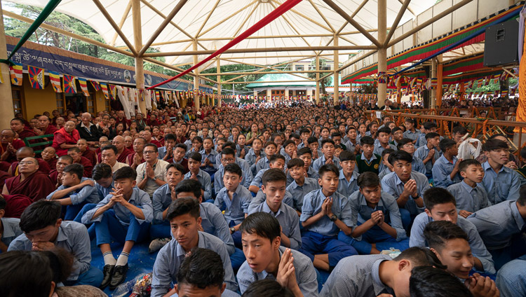 Young Tibetan students sitting in the Main Tibetan courtyard watching the Long Life Offering Ceremony for His Holiness the Dalai Lama on big screens in Dharamsala, HP, India on May 17, 2019. Photo by Tenzin Choejor