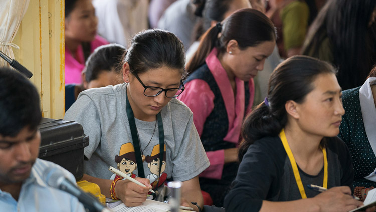 Members of the audience taking notes during His Holiness the Dalai Lama's teaching for young Tibetans at the Main Tibetan Temple in Dharamsala, HP, India on June 3, 2019. Photo by Tenzin Choejor