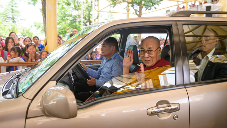 His Holiness the Dalai Lama waving to members of the crowd as he leaves the Main Tibetan Temple courtyard for his residence at the conclusion of his teaching for young Tibetans in Dharamsala, HP, India on June 3, 2019. Photo by Tenzin Choejor