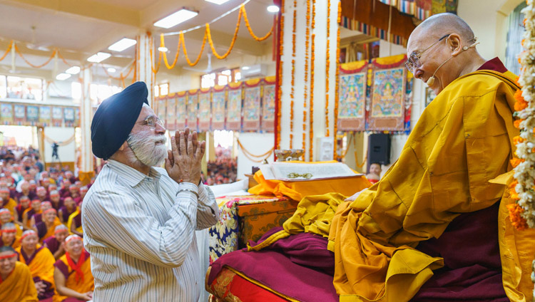 His Holiness the Dalai Lama greeting a Sikh man invited to come to the stage during the Avalokiteshvara Empowerment at the Main Tibetan Temple in Dharamsala, HP, India on June 5, 2019. Photo by Tenzin Choejor