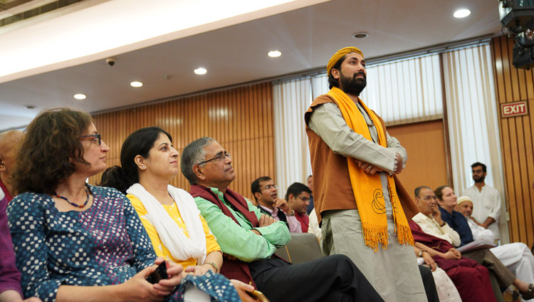 A member of the audience listening to His Holiness the Dalai Lama answering his question during the conference on "Celebrating Diversity in the Muslim World" at the India International Centre in New Delhi, India on June 15, 2019. Photo by Tenzin Choejor