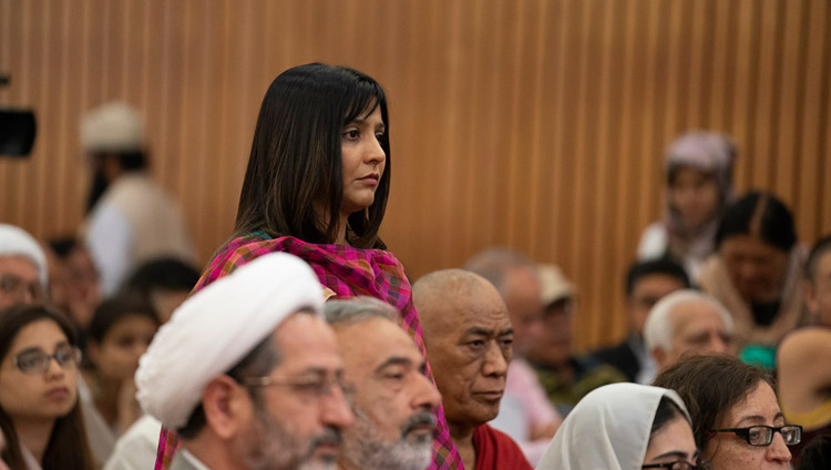 A member of the audience listening to His Holiness the Dalai Lama answering her question during the conference on "Celebrating Diversity in the Muslim World" at the India International Centre in New Delhi, India on June 15, 2019. Photo by Tenzin Choejor