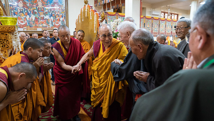 His Holiness the Dalai Lama greeting retired CTA officials as he arrives inside the Main Tibetan Temple in Dharamsala, HP, India on July 5, 2019. Photo by Tenzin Choejor