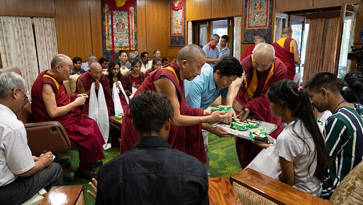 His Holiness the Dalai Lama sharing his birthday cake with community reprensentatives, staff and students of Tong-Len during their meeting at his residence in Dharamsala, HP, India on July 7, 2019. Photo by Tenzin Choejor