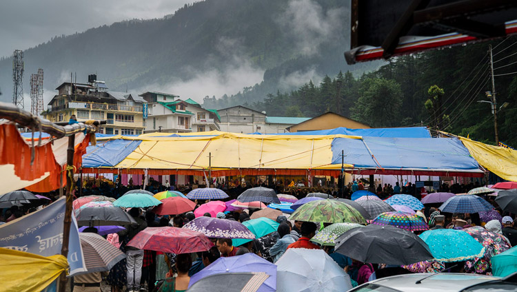 A view of the covered venue with an estimated 8000 people, some using umbrellas to protect agains the rain, during the Empowerment of Mahakarunika Lokeshvara given by His Holiness the Dalai Lama in Manali, HP, India on August 17, 2019. Photo by Tenzin Choejor