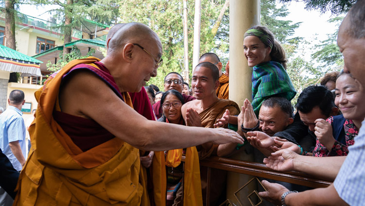 His Holiness the Dalai Lama greeting members of the crowd as he walks to the Main Tibetan Temple for the first day of teachings in Dharamsala, HP, India on September 4, 2019. Photo by Tenzin Choejor