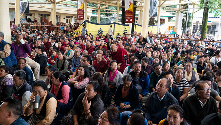 Members of the crowd sitting in courtyard of the Main Tibetan Temple watching His Holiness the Dalai Lama speaking on the second day of his teachings in Dharamsala, HP, India on September 5, 2019. Photo by Matteo Passigato