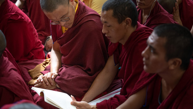 Monks following the text during the third day of His Holiness the Dalai Lama's teachings at the Main Tibetan Temple in Dharamsala, HP, India on September 6, 2019. Photo by Matteo Passigato