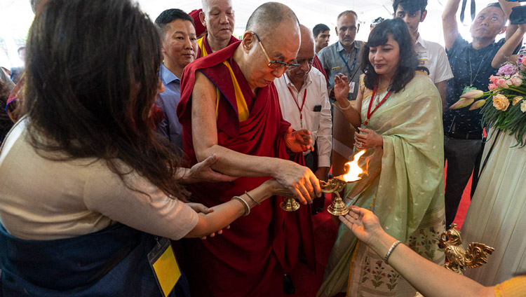 His Holiness the Dalai Lama lighting a lamp before taking his seat for his talk to students at Shri Ram School in New Delhi, India on September 20, 2019. Photo by Tenzin Choejor