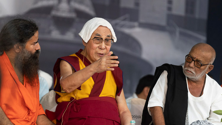 Baba Ramdev. and Morari Bapuji look on as His Holiness the Dalai Lama addresses the gathering during the interfaith program at Gandhi Ashram in New Delhi, India on September 25, 2019. Photo by Tenzin Choejor