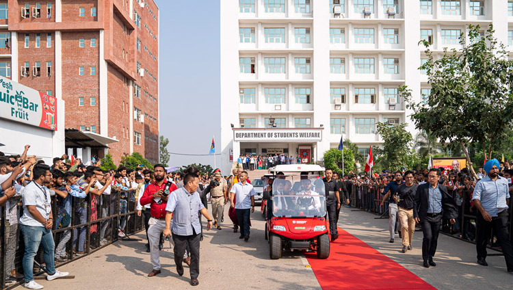 His Holiness the Dalai Lama riding in an electric buggy to the amphitheater for his talk at Chandigarh University in Chandigarh, India on October 15, 2019. Photo by Tenzin Choejor