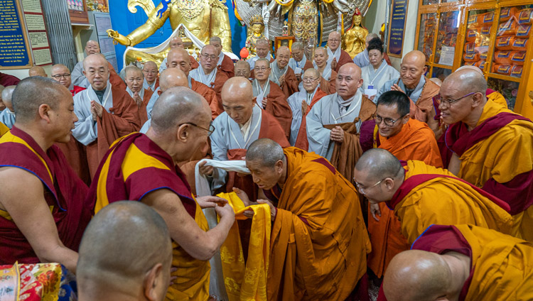 His Holiness the Dalai Lama greeting monks from Korea as he arrives for the first day of teachings at the Main Tibetan Temple in Dharamsala, HP, India on November 4, 2019. Photo by Ven Tenzin Jamphel