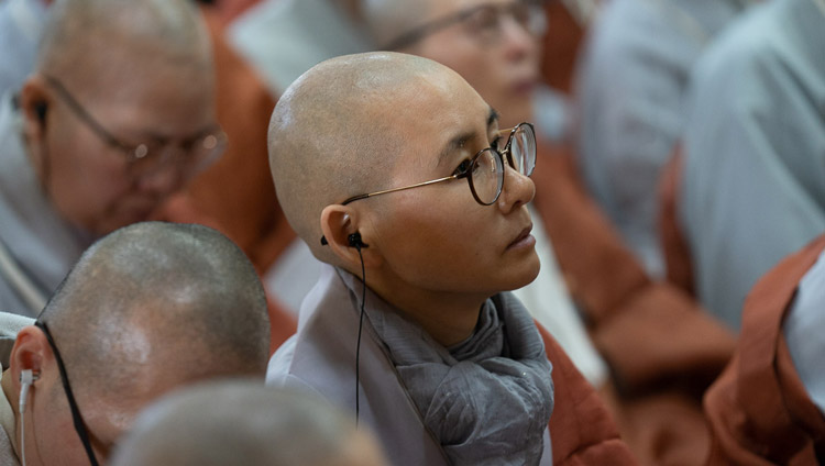 A Korean nun listening to a translation of His Holiness the Dalai Lama's teachings at the Main Tibetan Temple in Dharamsala, HP, India on November 4, 2019. Photo by Ven Tenzin Jamphel