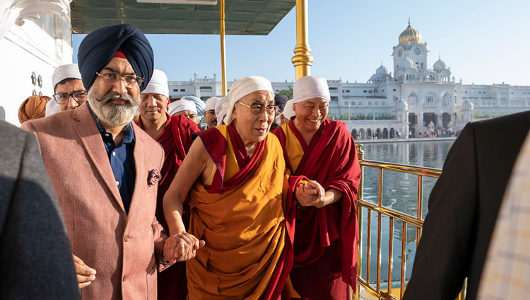 His Holiness the Dalai Lama walking down the causeway to the Dabar Shahib at the Golden Temple in Amritsar, Punjab, India on November 9, 2019. Photo by Tenzin Choejor