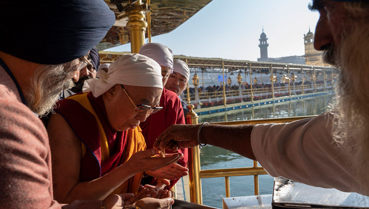 His Holiness the Dalai Lama receiving ‘prasad’, blessed food, that is offered to each pilgrim as he leaves the Darbar Sahib at the the Golden Temple in Amritsar, Punjab, India on November 9, 2019. Photo by Tenzin Choejor