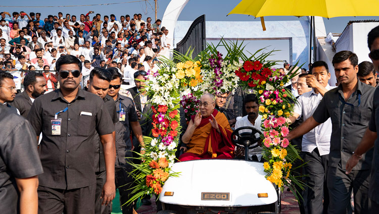 His Holiness the Dalai Lama riding in a golf-cart to the stage at the stadium of PES College of Physical Education in Aurangabad, Maharashtra, India on November 24, 2019. Photo by Tenzin Choejor