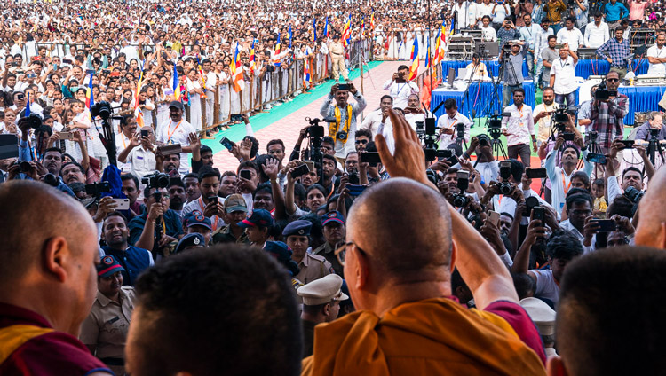 His Holiness the Dalai Lama waving to the crowd as he prepares to leave the stage at the end of his talk at PES College of Physical Education in Aurangabad, Maharashtra, India on November 24, 2019. Photo by Tenzin Choejor