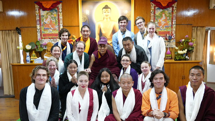 His Holiness the Dalai Lama wearing a cap presented by students from Earlham College during a group photo after their meeting at his residence in Dharamsala, HP, India on December 2, 2019. Photo by Ven Tenzin Jamphel