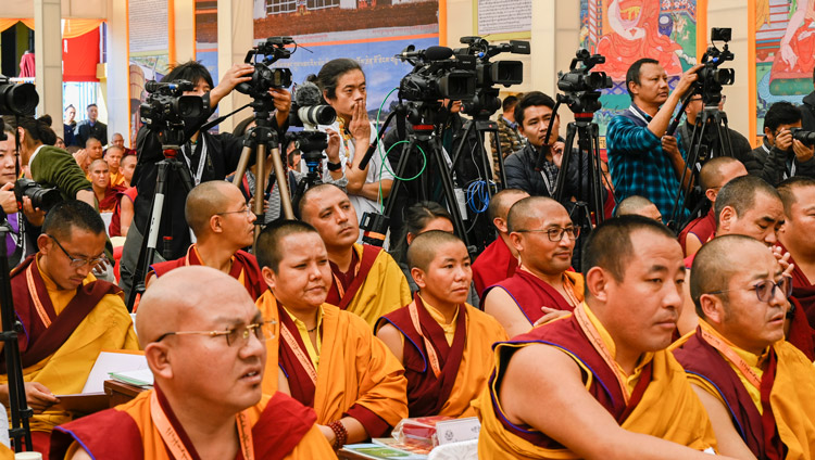 A view of members of the press filming His Holiness the Dalai Lama speaking at the inauguration of he Symposium on Monastic Education to mark the 25th anniversary of Kirti Jepa Dratsang in Dharamsala, HP, India on December 7, 2019. Photo by Manuel Bauer