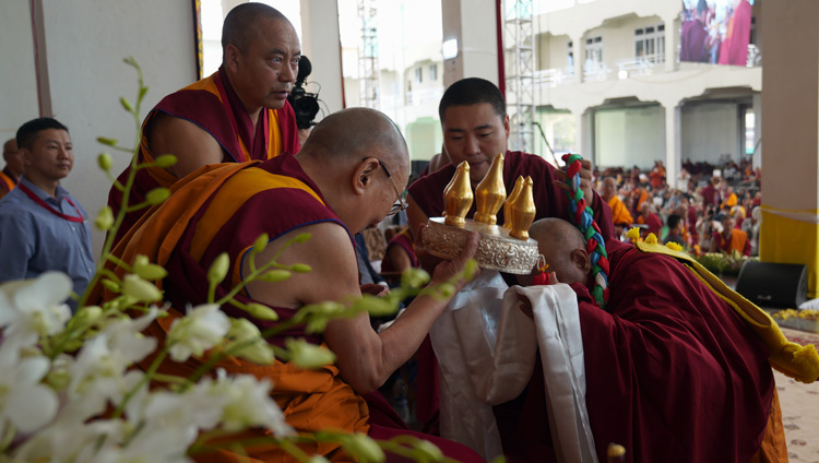 Abbot Lobsang Gyaltsen offering a mandala and the threefold representations of the Buddha’s body, speech and mind at the inauguration of Drepung Gomang Monastery's new debate yard in Mundgod, Karnataka, India on December 14, 2019. Photo by Lobsang Tsering