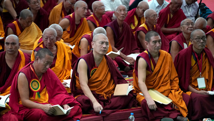 Members of the audience following the text during His Holiness the Dalai Lama's teaching at the new Drepung Gomang Monastery debate yard in Mundgod, Karnataka, India on December 14, 2019. Photo by Lobsang Tsering