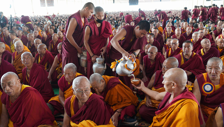 Volunteers serving tea to members of the crowd of over 25,000 at the Drepung Loseling debate yard in Mundgod, Karnataka, India on December 16, 2019. Photo by Lobsang Tsering Volunteers serving tea to members of the crowd of over 25,000 at the Drepung Loseling debate yard in Mundgod, Karnataka, India on December 16, 2019. Photo by Lobsang Tsering